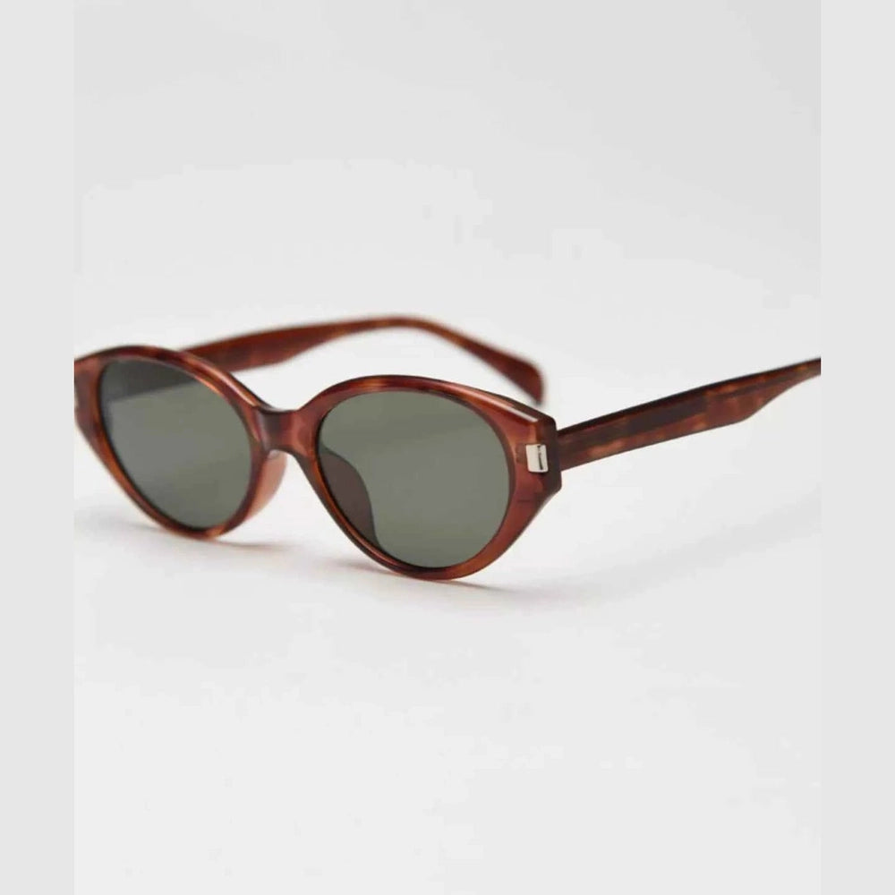 Tortoiseshell acetate cat-eye sunglasses with green lenses and silver metal detail