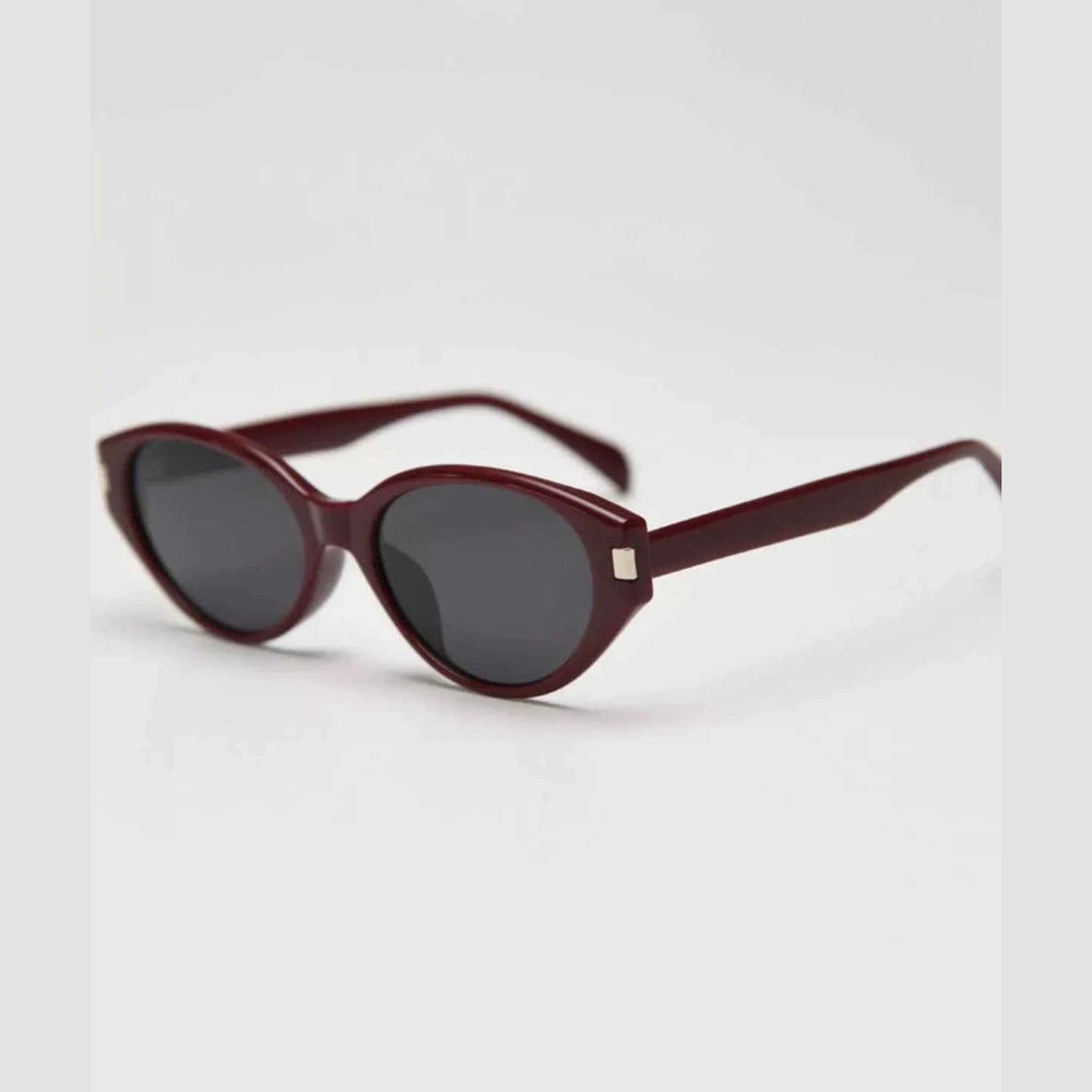 Burgundy acetate cat-eye sunglasses with dark gray lenses and silver temple accent