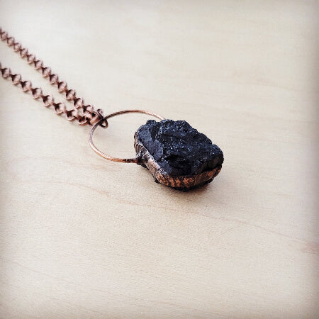 Close-up of antique copper twisted link chain and rough black agate pendant