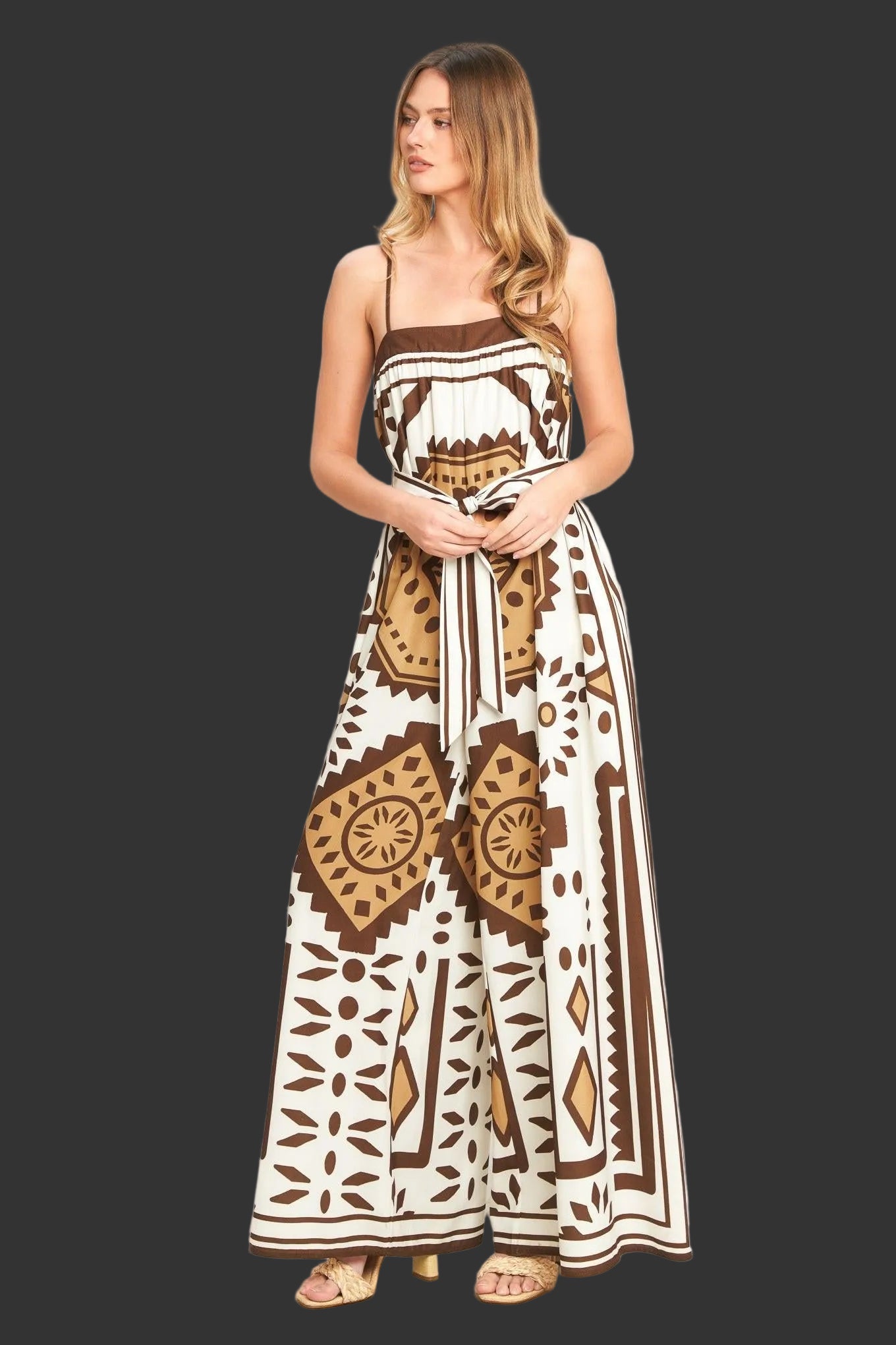 Woman wearing a long, patterned dress with a white background