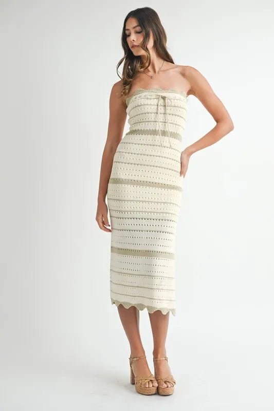 Woman wearing a strapless, patterned dress on a white background