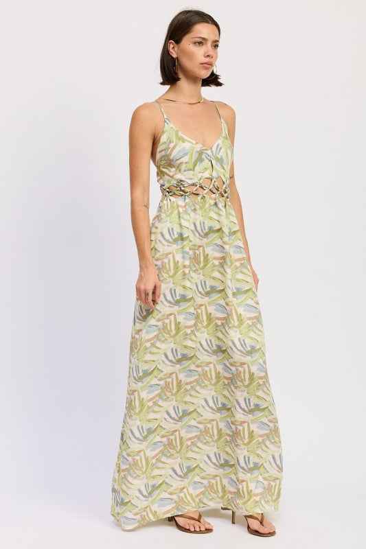 Model is wearing floral open‑back maxi dress for warm‑weather boho style.