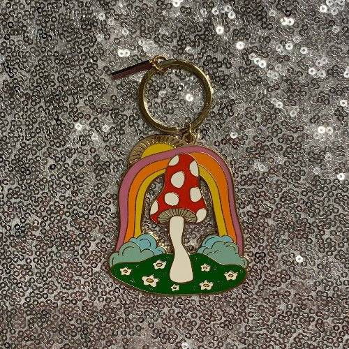 Top view red toadstool keychain on sequin background