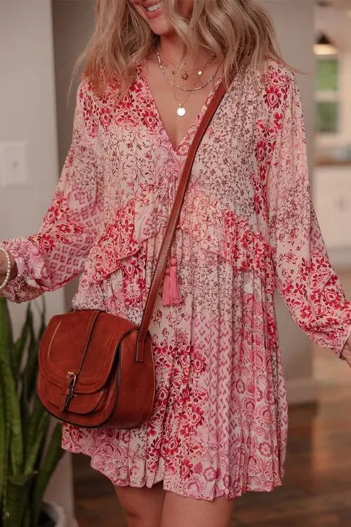 Flowing pink floral print mini dress with gathered cuffs and front tassel detail