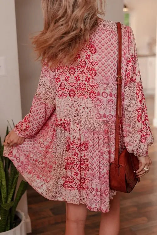 Pink floral patchwork mini dress back view with tiered ruffles and long sleeves
