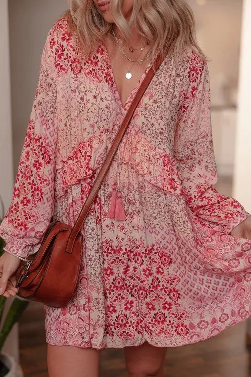 Side view of bohemian pink floral mini dress with ruffled waist and tassel tie
