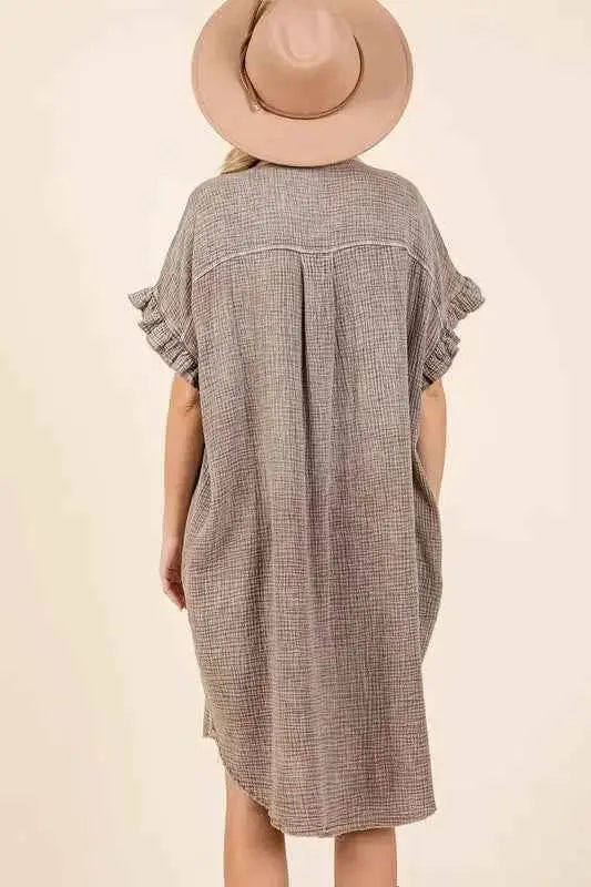 Back view of relaxed fit cotton gauze mini dress featuring centered seam and raw hem
