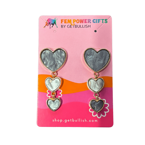 Heart-shaped earrings on a pink card with 'Fem Power Gifts by GetBullish' branding.