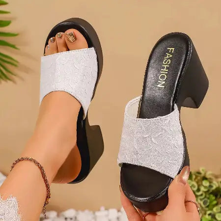 Black and white high-heeled sandals with 'FASHION' text on a beige background