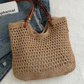 Brown crochet bag with brown handle on denim jeans against a light background