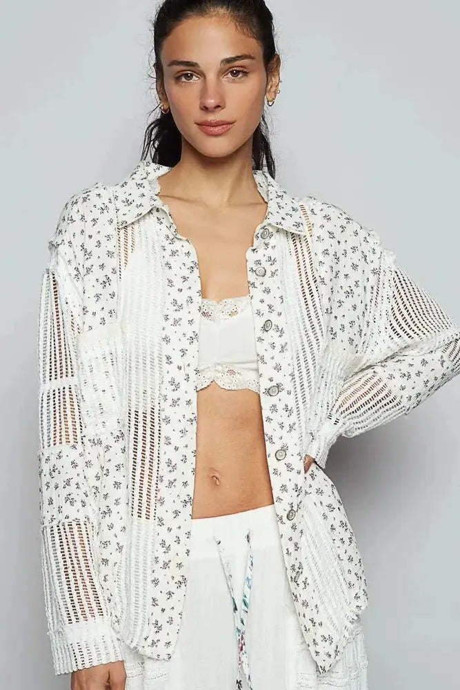 Woman wearing a white crochet top with floral patterns on a gray background