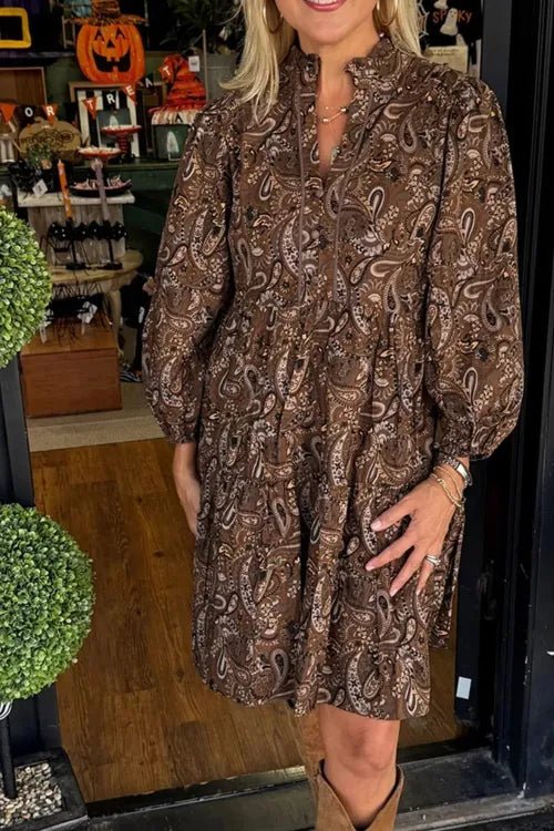 Woman wearing a brown patterned dress in a store setting