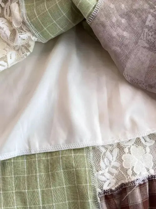 Close-up of layered fabric with lace and checkered patterns