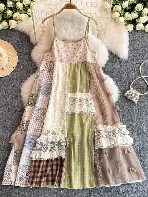 Patchwork dress on a hanger with decorative elements on a gray surface