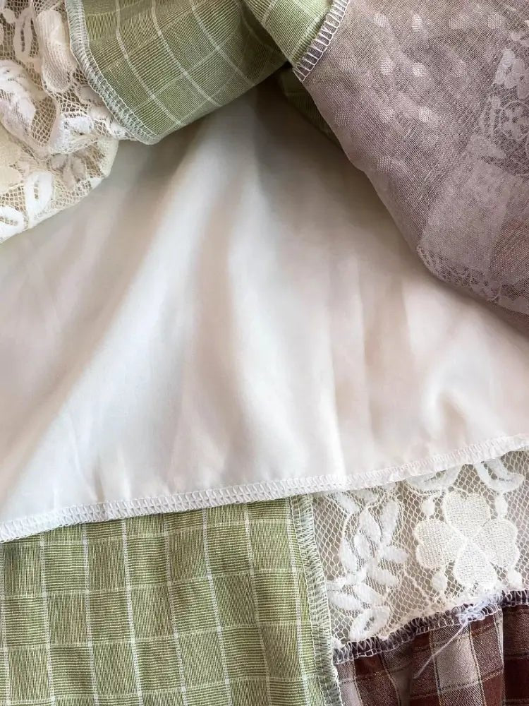 Close-up of layered fabric with lace and checkered patterns