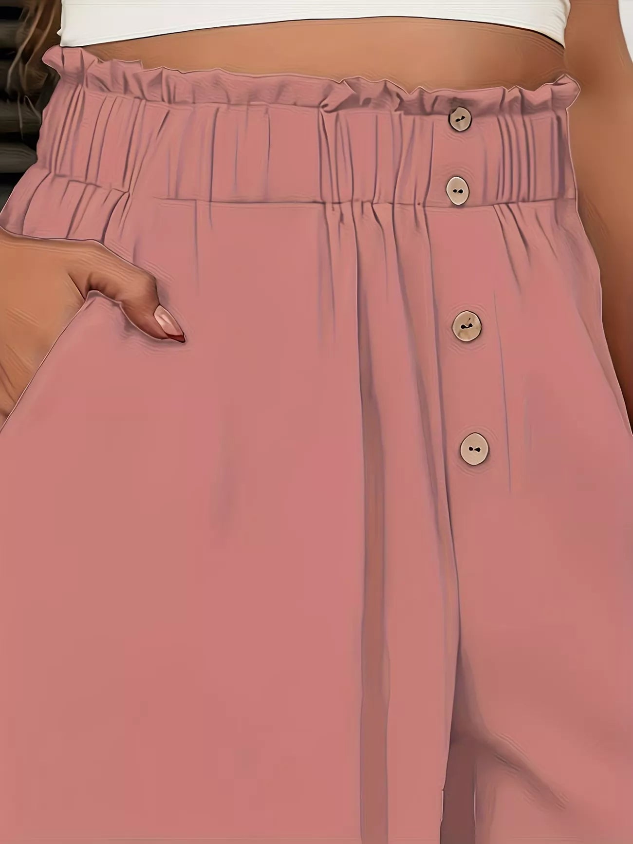 Close-up of pink pants with button details