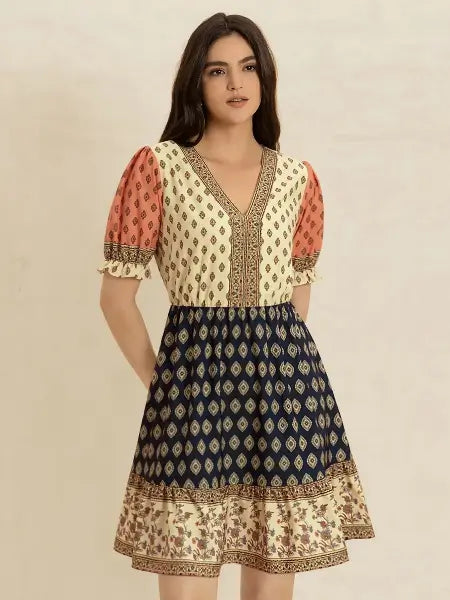 Woman wearing a patterned dress with a beige background