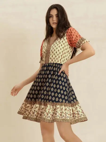 Woman wearing a patterned dress with a neutral background