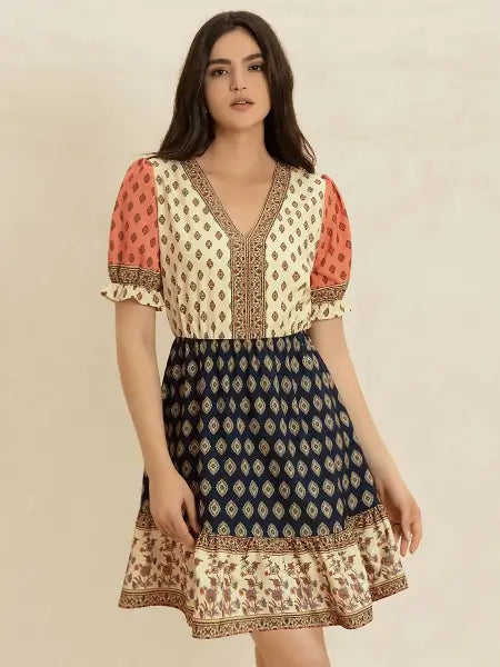 Woman wearing a patterned dress with a beige background
