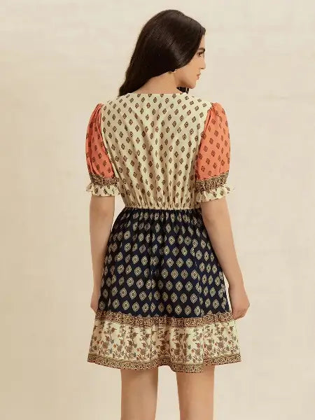 Woman wearing a patterned outfit with a beige background