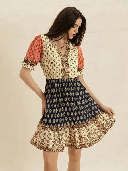 Woman wearing a patterned dress with a beige background