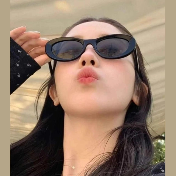 Matte black slim profile cat eye shades held by model