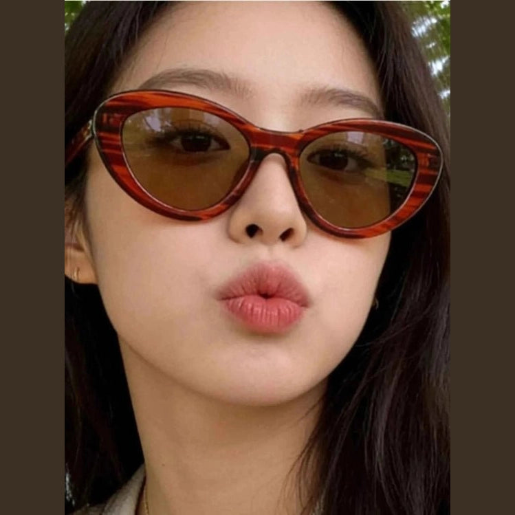 Tortoiseshell patterned cat eye sunglasses with brown lenses close-up