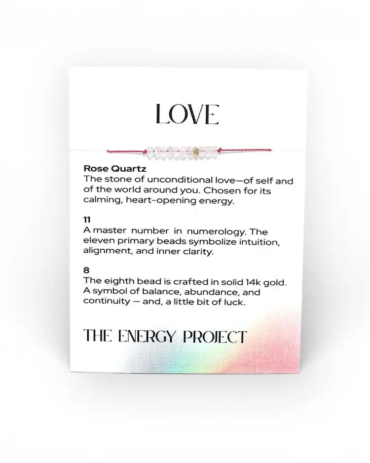 Rose Quartz bracelet with descriptive card on a white background