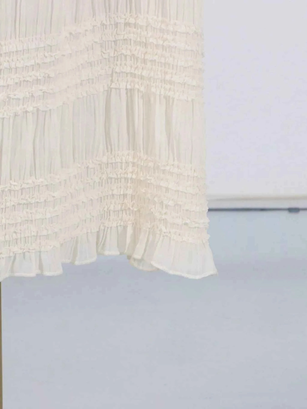 White textured fabric on a light blue background