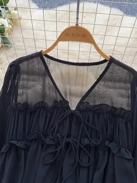 Blue blouse on a hanger against a tiled wall background