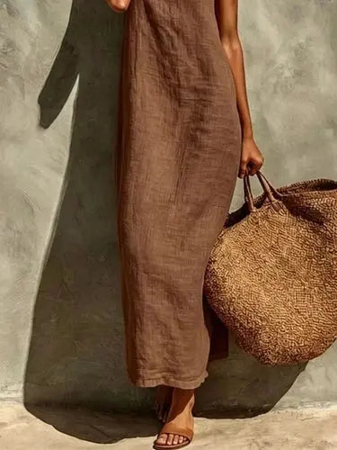 Brown side profile view of flowing unlined maxi dress with textured drape