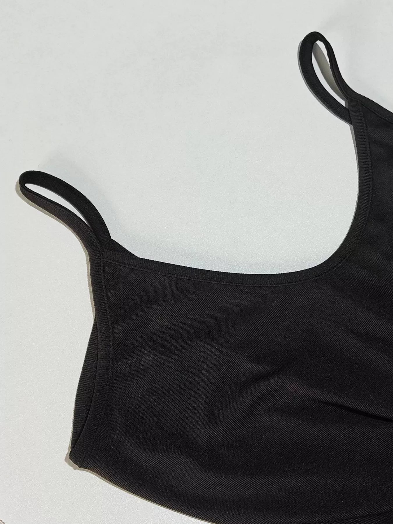 Black tank top on a light gray background