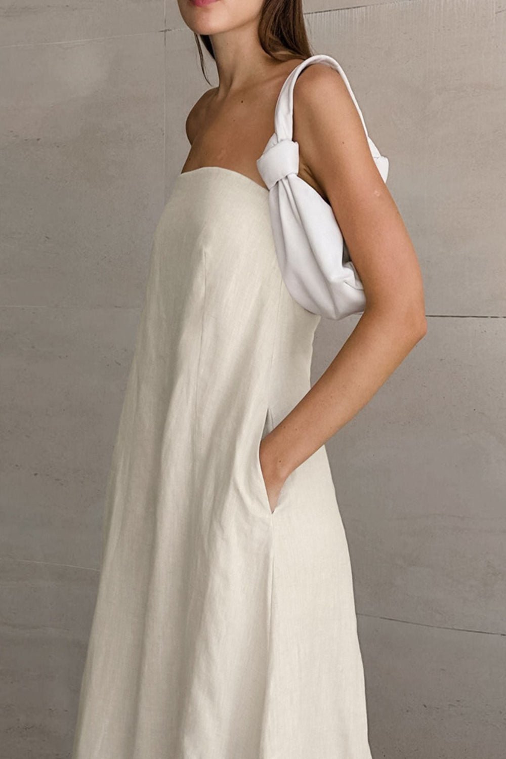 Smocked Back Tube Dress - Salty Season LLC Woman wearing a white dress with a bow detail on a neutral background