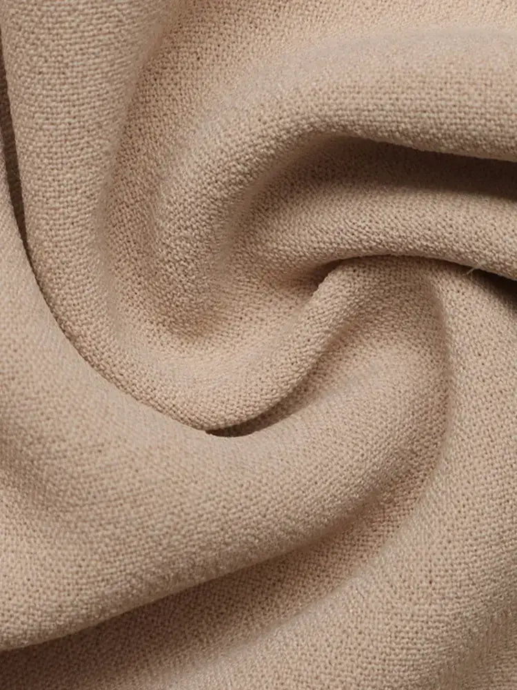 Close-up of beige fabric with a textured pattern