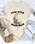 Beige t-shirt with 'stay wild moon child' design, mug, sweater, and jeans on a white background
