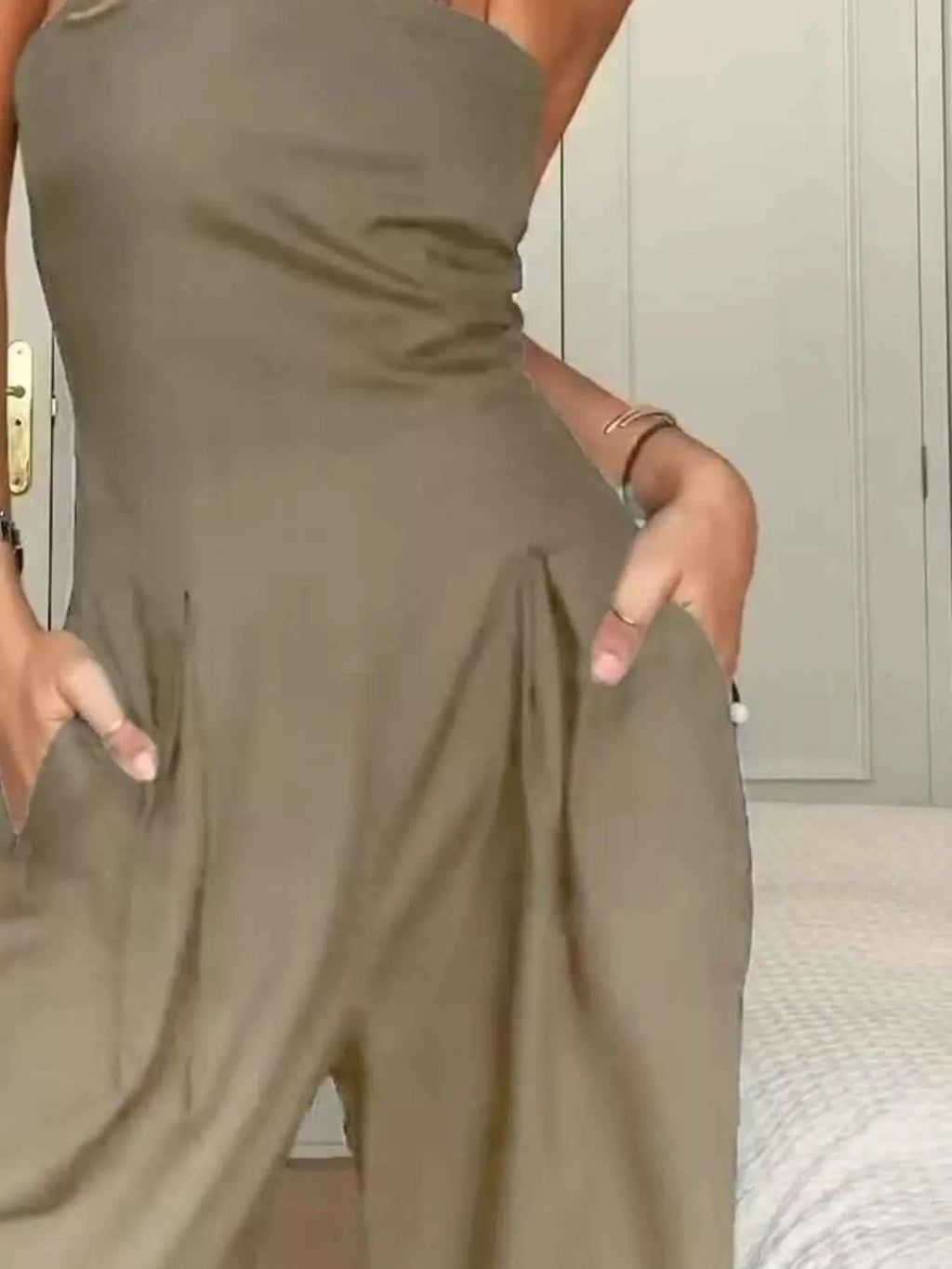 Person wearing a green jumpsuit indoors.