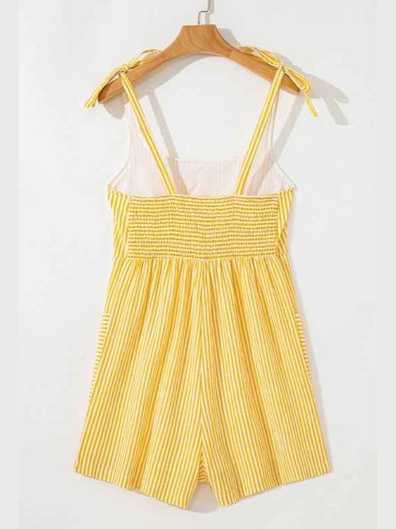 Yellow striped romper on a hanger against a white background
