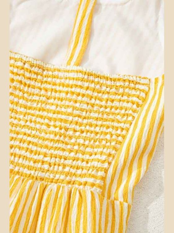 Close-up of a yellow and white striped fabric with a textured pattern.