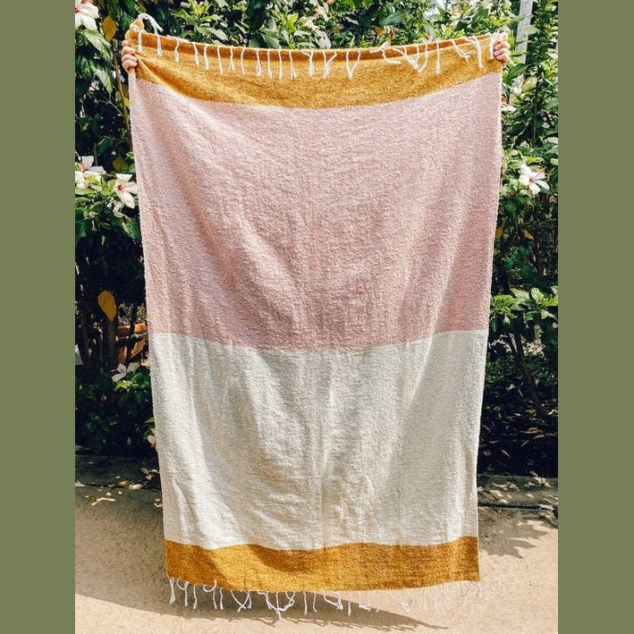 Close-up of looped weave texture on mustard pink cream Sundream throw blanket