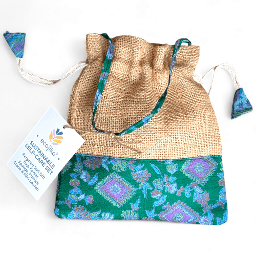 Jute drawstring bag with green and blue patterned fabric, featuring an eco-friendly label.