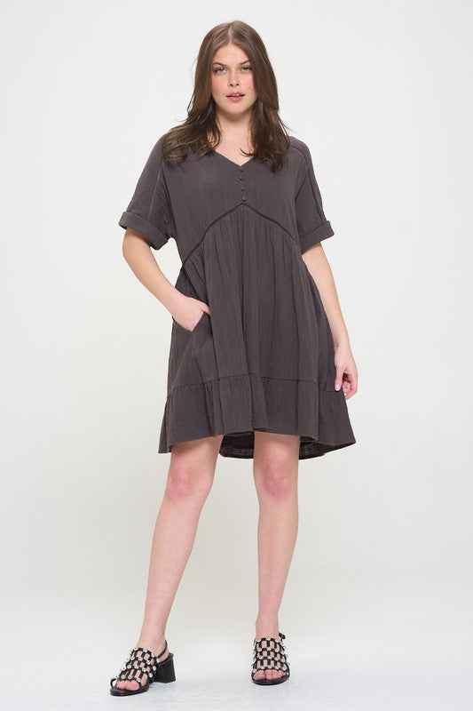 Woman wearing a gray dress on a white background