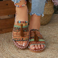 Colorful sandals with patterned straps worn on a woven mat.