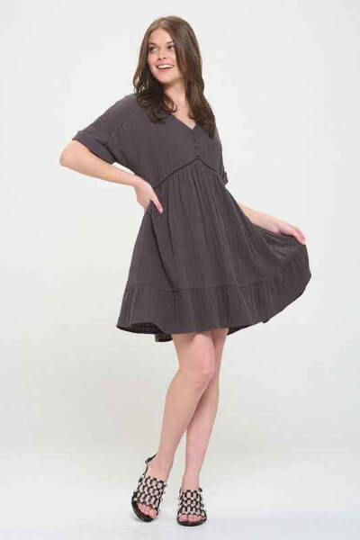 Woman wearing a dark gray dress on a white background