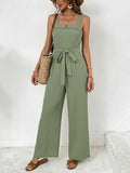 Woman wearing a green jumpsuit with a white background