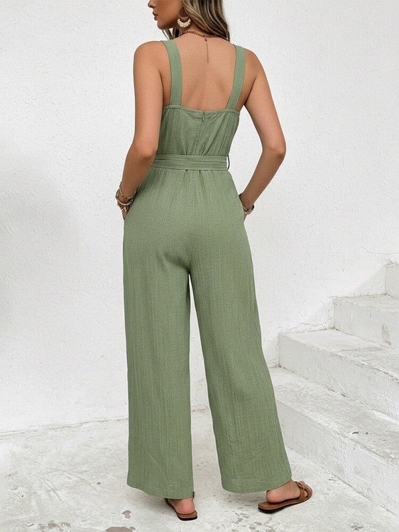 Woman wearing a green jumpsuit on a white background