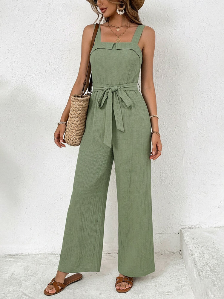 Woman wearing a green jumpsuit with a white background