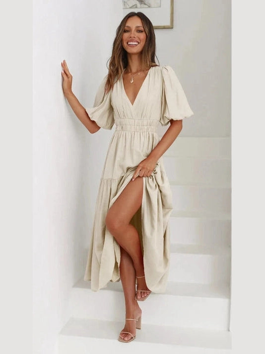 Woman wearing a beige dress with a white background
