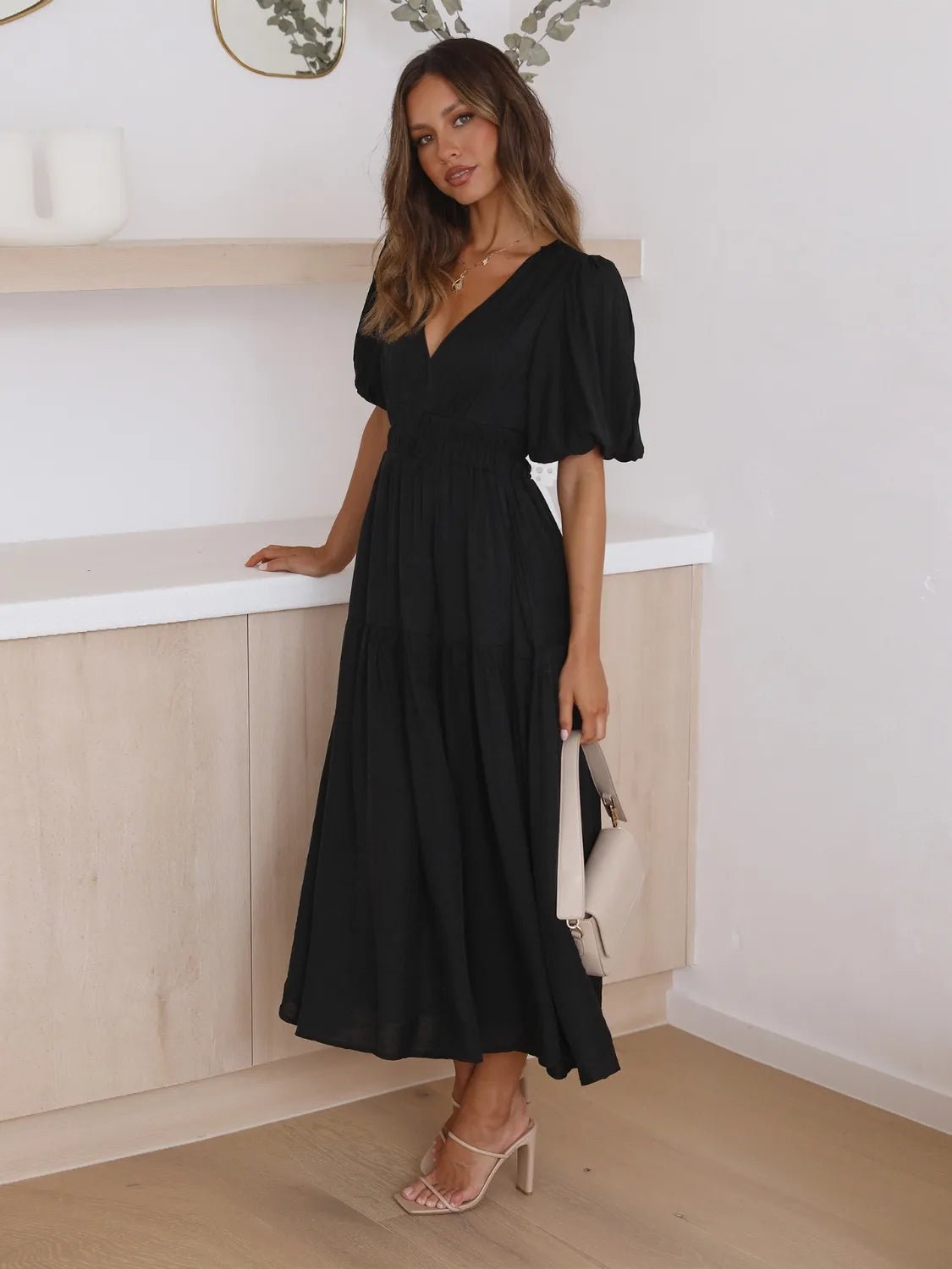 Woman wearing a black dress in an indoor setting