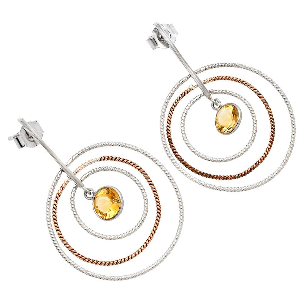 Pair of hoop earrings with circular design and embedded stones on a white background