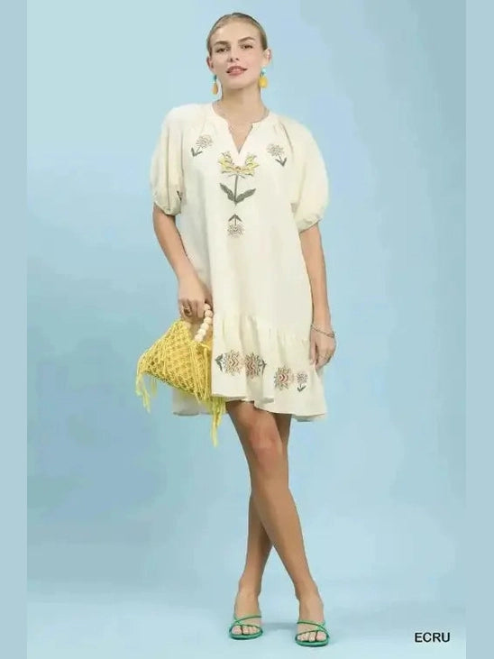 Cream baby-doll dress styled with woven beaded bag for boho summer look